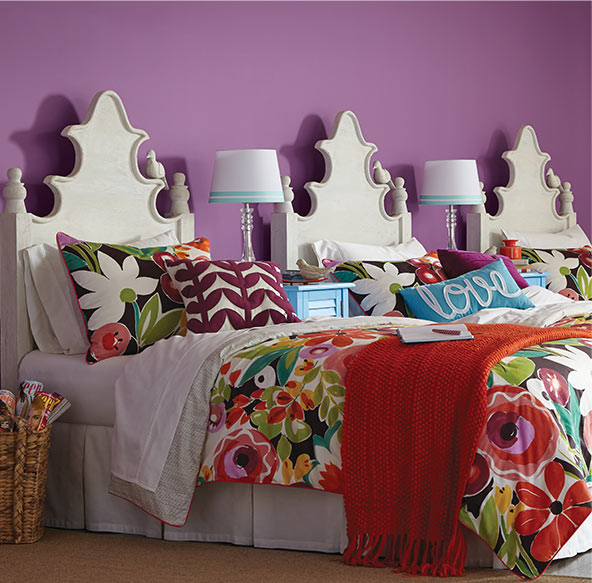 In a bedroom with a bold color on the walls, create visual interest by painting your headboard a bright white that stands out. Add some vibrant bedding to make it really pop.