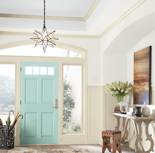 Entryway featuring Sherwin-Williams Extra White SW 7006 as the main wall color and Blue Sky SW 0063 as the door color